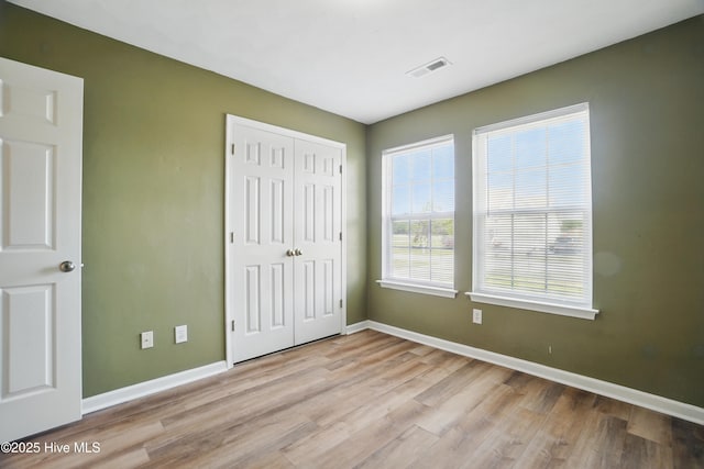 101 Whitetail Ct, South Mills, NC 27976 - unfurnished bedroom with visible vents, baseboards, and wood finished floors