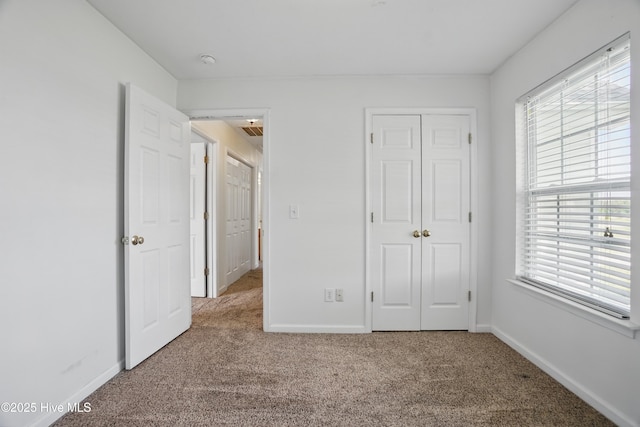 101 Whitetail Ct, South Mills, NC 27976 - unfurnished bedroom featuring a closet, baseboards, and carpet flooring
