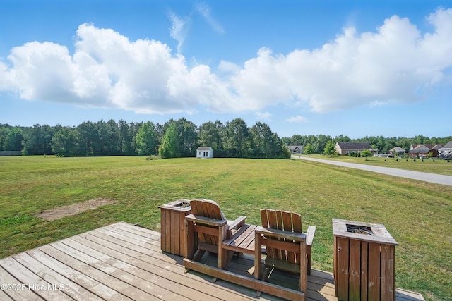 101 Whitetail Ct, South Mills, NC 27976 - wooden deck with a storage unit, an outdoor structure, a yard, and a fire pit