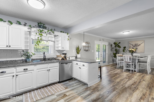 803 Oakwood Ave, Jacksonville, NC 28546 - kitchen featuring stainless steel dishwasher, open shelves, a peninsula, white cabinetry, and a sink