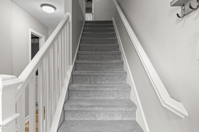 803 Oakwood Ave, Jacksonville, NC 28546 - staircase with carpet flooring and a textured ceiling