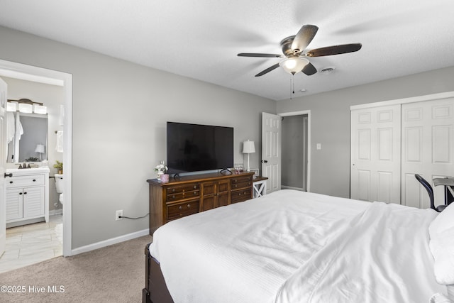 803 Oakwood Ave, Jacksonville, NC 28546 - bedroom with light carpet, a ceiling fan, baseboards, ensuite bathroom, and a closet