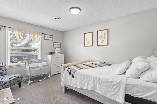 803 Oakwood Ave, Jacksonville, NC 28546 - carpeted bedroom with a textured ceiling and visible vents