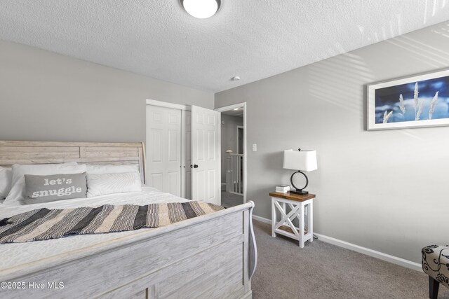 803 Oakwood Ave, Jacksonville, NC 28546 - bedroom with baseboards, carpet flooring, a textured ceiling, and a closet