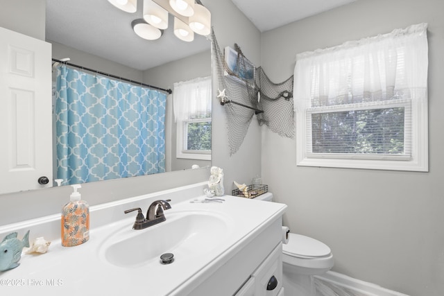 803 Oakwood Ave, Jacksonville, NC 28546 - bathroom featuring toilet, a shower with curtain, baseboards, and vanity