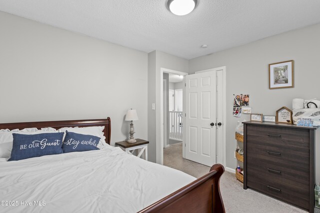 803 Oakwood Ave, Jacksonville, NC 28546 - carpeted bedroom featuring a textured ceiling and baseboards