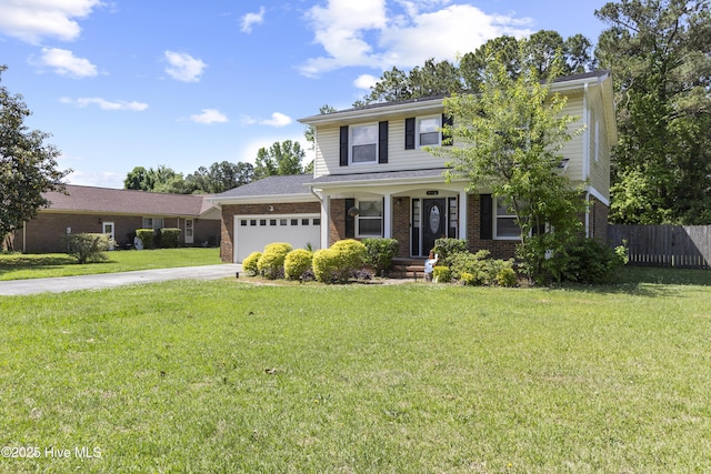803 Oakwood Ave, Jacksonville, NC 28546 - traditional home featuring fence, brick siding, a garage, a front yard, and concrete driveway
