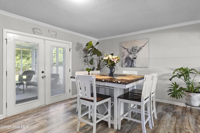 803 Oakwood Ave, Jacksonville, NC 28546 - dining room with ornamental molding, wood finished floors, baseboards, a textured ceiling, and french doors