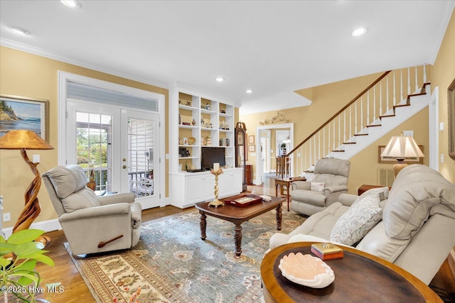 living area featuring stairs, wood finished floors, recessed lighting, baseboards, and ornamental molding