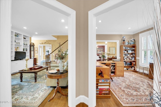 entrance foyer with wood finished floors, stairs, crown molding, baseboards, and recessed lighting