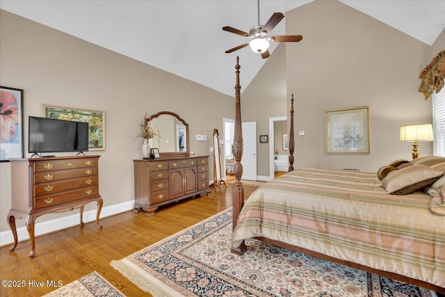 bedroom with high vaulted ceiling, light wood finished floors, baseboards, and ceiling fan