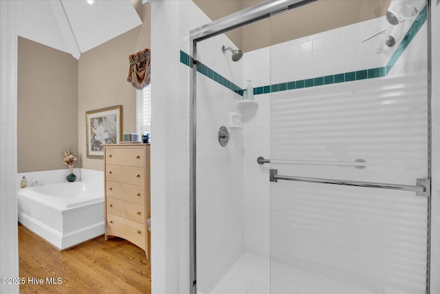 full bathroom with a shower stall, wood finished floors, and a garden tub