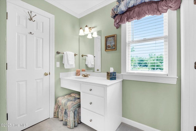 bathroom with ornamental molding, healthy amount of natural light, vanity, and baseboards