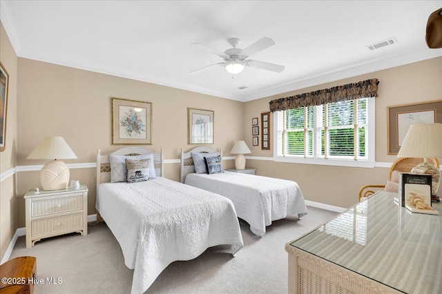 carpeted bedroom featuring baseboards, ornamental molding, and ceiling fan