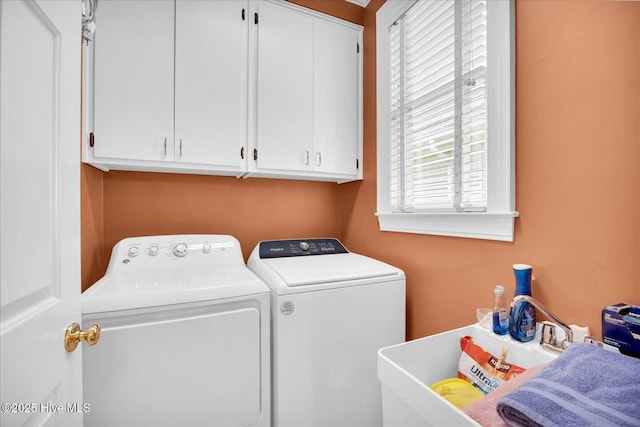 laundry room with independent washer and dryer and cabinet space