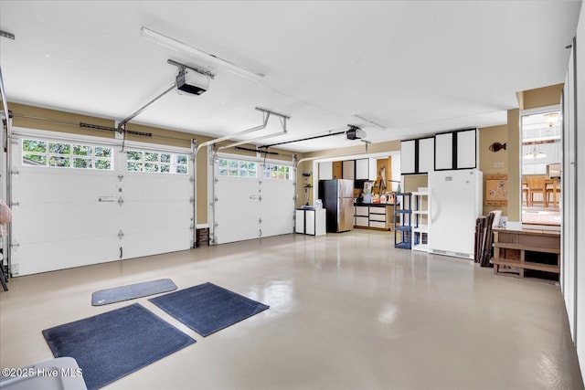 garage with a garage door opener and freestanding refrigerator