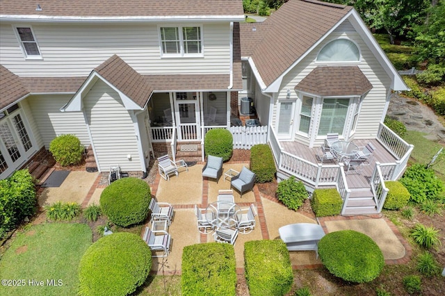 rear view of house with a patio area, fence, roof with shingles, and a wooden deck