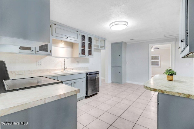 3210 Central Heights Rd, Goldsboro, NC 27534 - kitchen featuring a sink, light tile patterned floors, dishwasher, and light countertops
