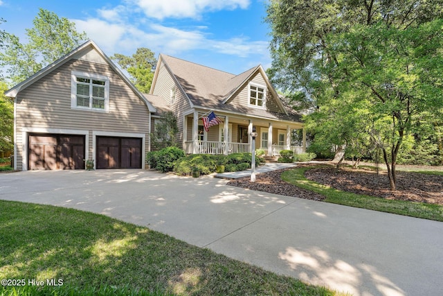 view of front facade with a porch, a garage, and driveway