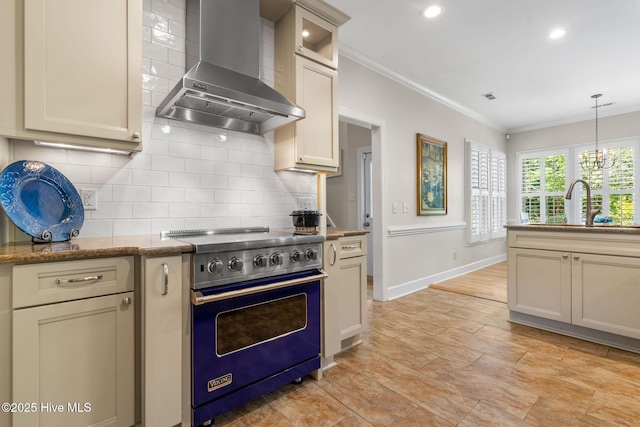 3504 Whimsy Way, Wilmington, NC 28411 - kitchen with wall chimney range hood, crown molding, designer range, decorative light fixtures, and backsplash