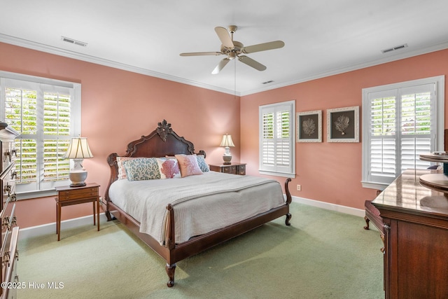 bedroom featuring visible vents, light carpet, and multiple windows