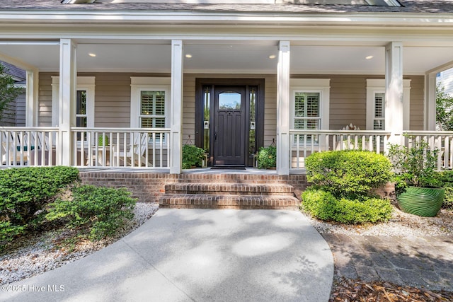 view of exterior entry with a porch
