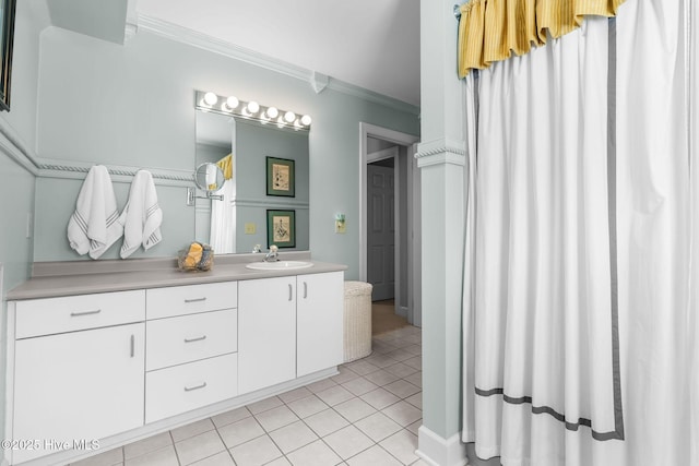 bathroom featuring tile patterned floors, ornamental molding, and vanity