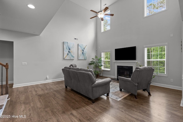 224 Pristine Ct, West End, NC 27376 - living room with high vaulted ceiling, a fireplace with flush hearth, baseboards, dark wood-style floors, and ceiling fan
