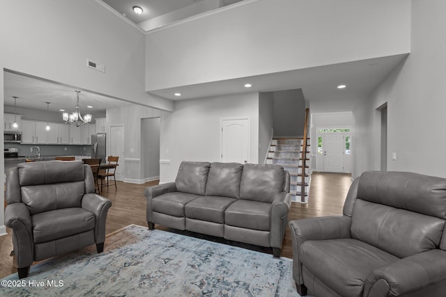224 Pristine Ct, West End, NC 27376 - living area with wood finished floors, a towering ceiling, a chandelier, baseboards, and recessed lighting
