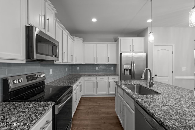 224 Pristine Ct, West End, NC 27376 - kitchen featuring appliances with stainless steel finishes, a sink, white cabinetry, dark stone countertops, and decorative backsplash