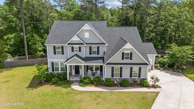224 Pristine Ct, West End, NC 27376 - view of front of home featuring a porch, roof with shingles, concrete driveway, and stone siding