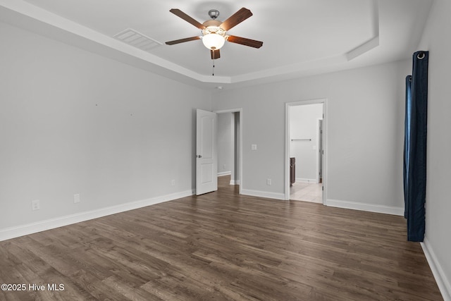 224 Pristine Ct, West End, NC 27376 - unfurnished bedroom with a tray ceiling, wood finished floors, baseboards, and ensuite bathroom