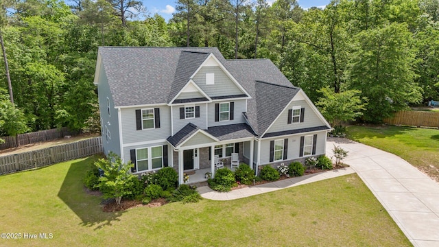 224 Pristine Ct, West End, NC 27376 - view of front of house featuring a porch, driveway, and roof with shingles