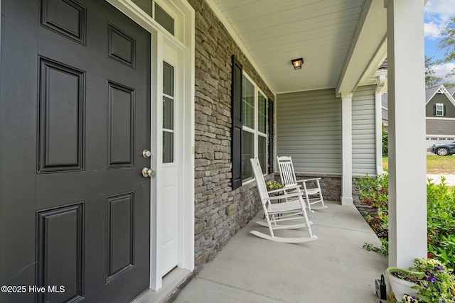 224 Pristine Ct, West End, NC 27376 - doorway to property with covered porch and stone siding