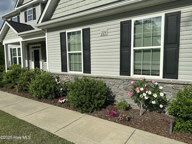 view of property exterior with stone siding