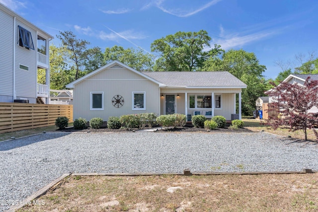 2005 E Oak Island Dr, Oak Island, NC 28465 - view of front facade featuring a shingled roof and fence