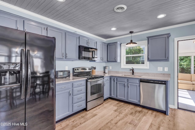 2005 E Oak Island Dr, Oak Island, NC 28465 - kitchen featuring a sink, crown molding, black appliances, and a healthy amount of sunlight