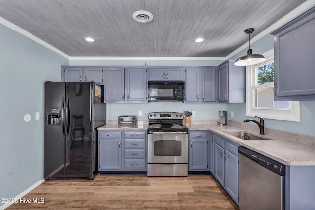 2005 E Oak Island Dr, Oak Island, NC 28465 - kitchen featuring crown molding, pendant lighting, light countertops, a sink, and black appliances