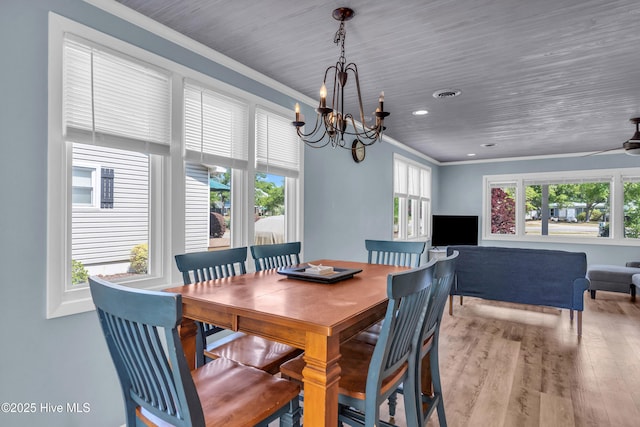 2005 E Oak Island Dr, Oak Island, NC 28465 - dining area with recessed lighting, a notable chandelier, ornamental molding, and wood finished floors