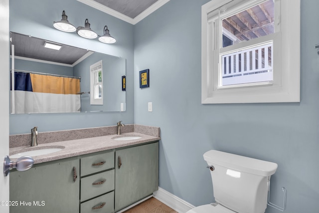 2005 E Oak Island Dr, Oak Island, NC 28465 - bathroom featuring baseboards, a sink, toilet, and ornamental molding
