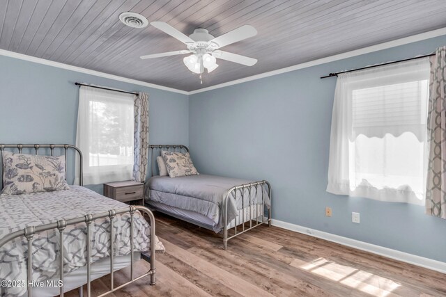 2005 E Oak Island Dr, Oak Island, NC 28465 - bedroom featuring ornamental molding, wood finished floors, and visible vents