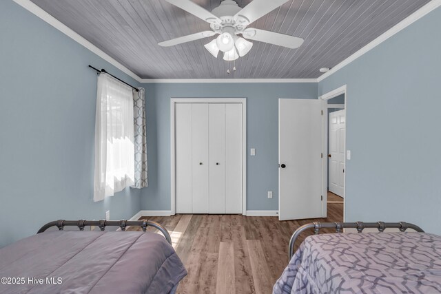 2005 E Oak Island Dr, Oak Island, NC 28465 - bedroom with crown molding, wood ceiling, wood finished floors, and a closet