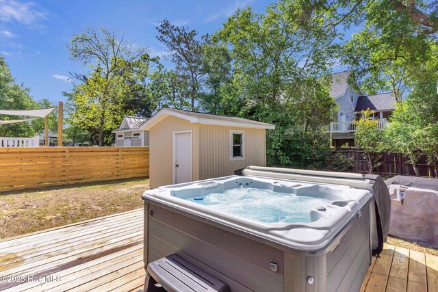 2005 E Oak Island Dr, Oak Island, NC 28465 - wooden terrace with a hot tub, an outbuilding, fence private yard, and a shed