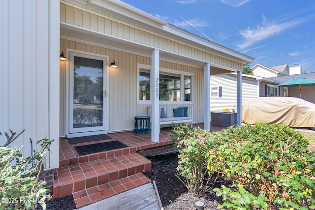 2005 E Oak Island Dr, Oak Island, NC 28465 - doorway to property featuring a porch
