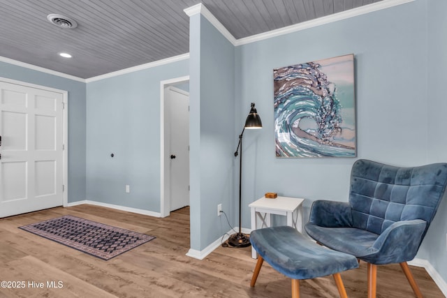 2005 E Oak Island Dr, Oak Island, NC 28465 - sitting room with crown molding, baseboards, wood finished floors, and visible vents