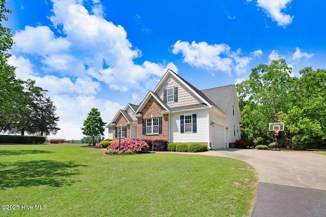 1171 Airport Rd, Pikeville, NC 27863 - craftsman-style house featuring a garage, driveway, a front lawn, and brick siding