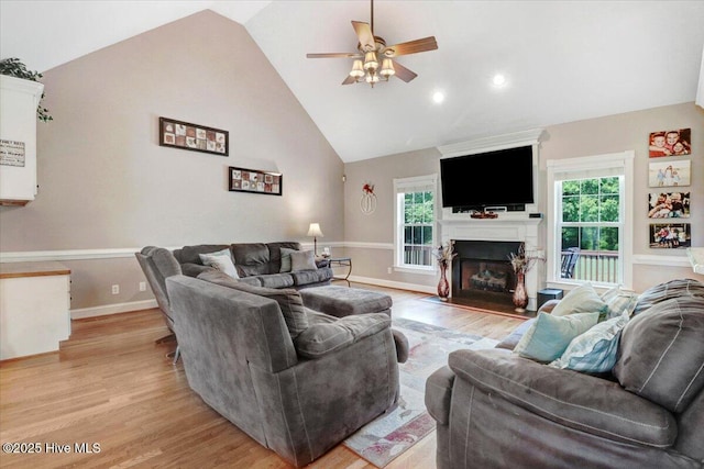 1171 Airport Rd, Pikeville, NC 27863 - living area featuring ceiling fan, a fireplace, light wood finished floors, and a wealth of natural light