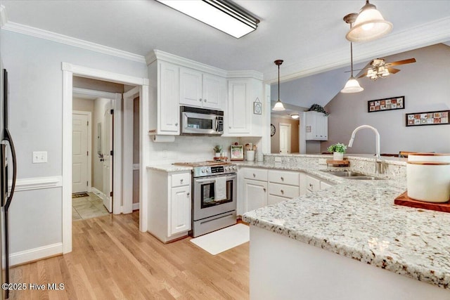 1171 Airport Rd, Pikeville, NC 27863 - kitchen with a sink, light wood-style floors, stainless steel appliances, white cabinetry, and ornamental molding