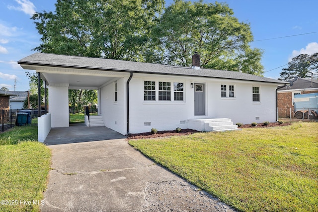 ranch-style home with brick siding, a front lawn, fence, and driveway