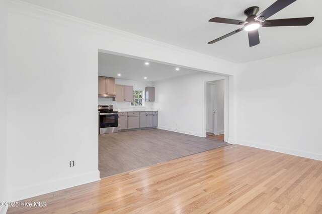 unfurnished living room featuring ceiling fan, recessed lighting, baseboards, light wood-type flooring, and ornamental molding